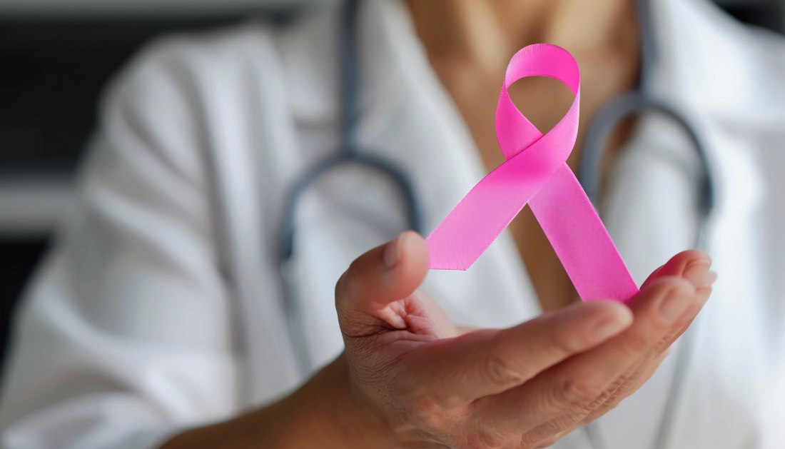 Image of doctor showing pink ribbon(breast cancer awareness).